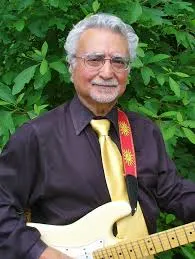 Sal Basile holds his guitar