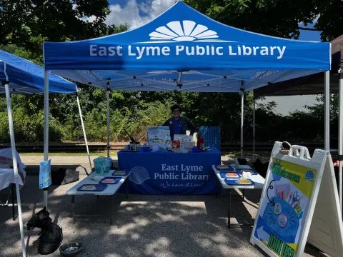 A picture of the library's tent at the farmer's market.