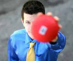 This is a photograph of comedic juggler Bryson Lang holding a red ball.