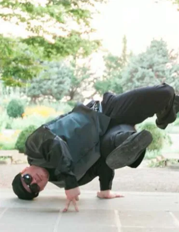 DJ Red Supreme (also known as Austin Daily) spins on his head in a break-dance move. 