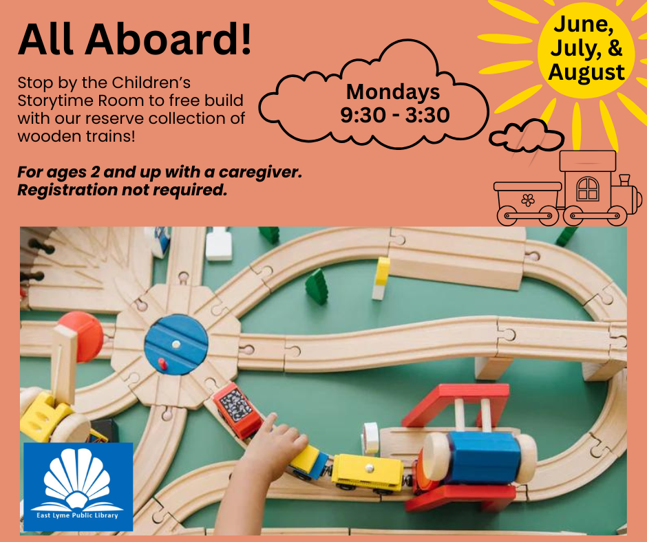 A child is driving a toy train on a wooden train track.