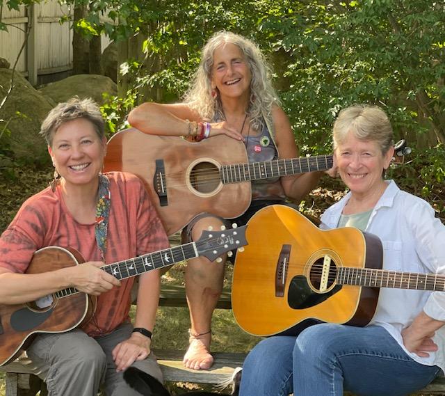 Image of performers holding guitars